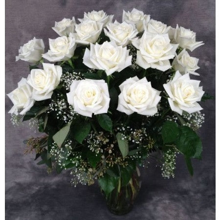 Dozen premium white roses arranged in a  vase with filler and greens