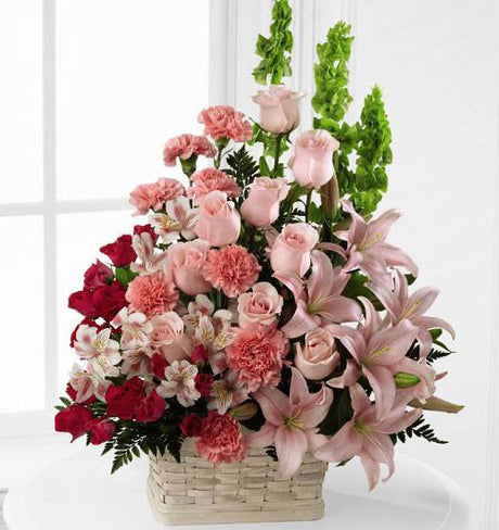 Beautiful spirit sympathy flower arrangement in basket with assorted pink flowers Medium