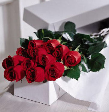 Dozen boxed roses arranged in a gift box