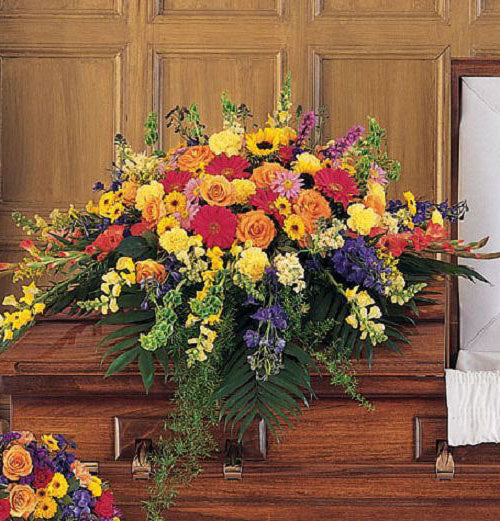 Celebration of Life Casket Spray of vibrant flowers