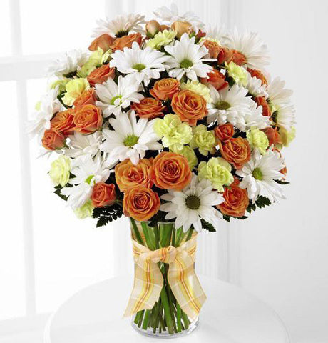 Charming grace bouquet of orange, yellow and white flowers arranged in glass vase Large