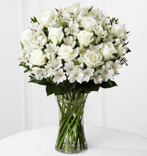 All white fresh flowers arranged in a gathering vase Large