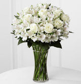 All white fresh flowers arranged in a gathering vase Medium