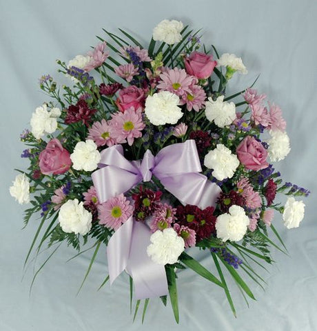 Condolences funeral flower basket of lavender, purple and white