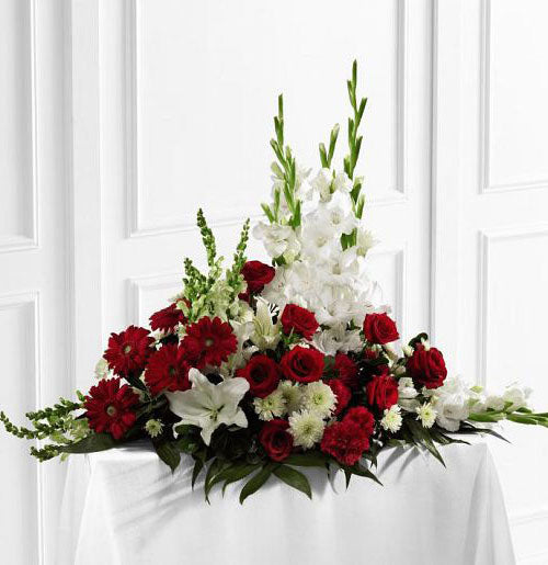 Crimson and white funeral flower arrangement of red and white flowers