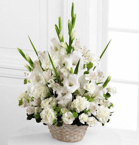 White handle basket filled with assorted white sympathy flowers Large