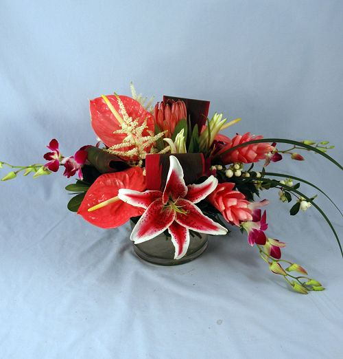 Exotics pinks tropical flower arrangement of stargazer lilies, orchids and anthurium