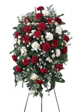 Crimson and white funeral flower standing spray of red and white carnations