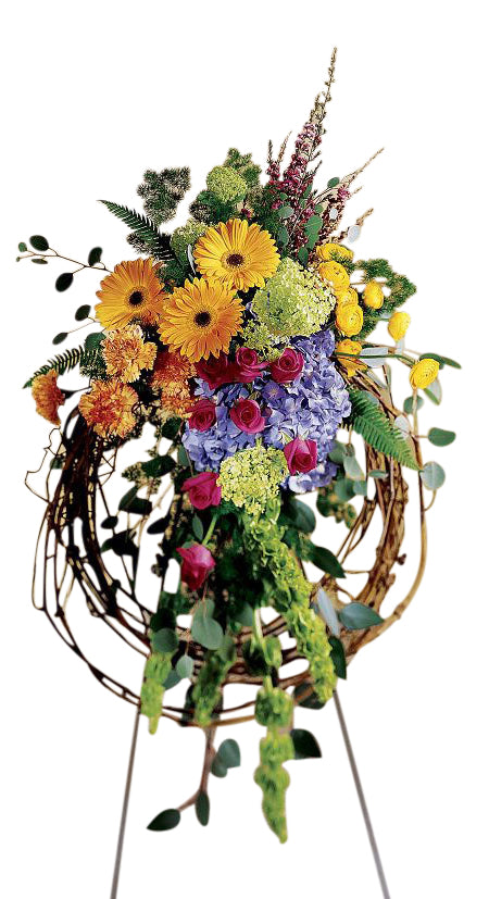 Stylish funeral flower wreath with vibrant gerbera daisies, hydrangea and roses