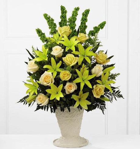 All yellow flowers in a one sided funeral flower arrangement Medium