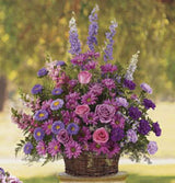 Gracious lavender funeral basket arrangement of all purple flowers