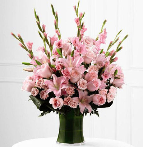 Gathering vase of blooming gladiolus for sympathy Large