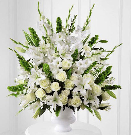 Morning stars funeral flower arrangement of all white flowers in a white urn Large