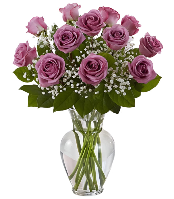 Dozen premium long stem lavender roses arranged in vase with filler