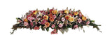 Funeral flower casket spray with soft pinks and yellows