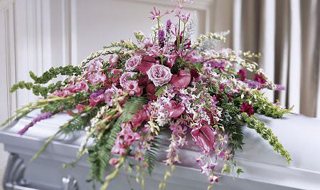 Casket spray of assorted lavender flowers for funeral