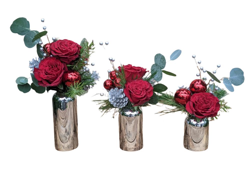 Cluster of 3 Christmas arrangements in silver vases