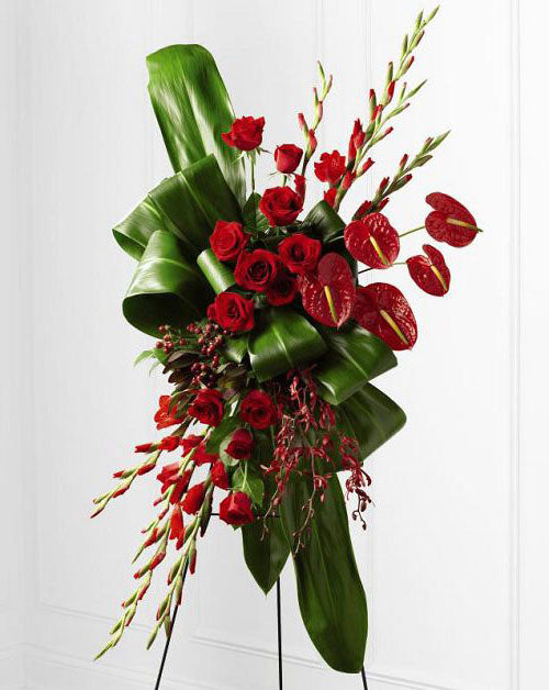 Sweet Thought Funeral Flower Standing Spray of tropical red anthurium, roses, orchids and gladiola