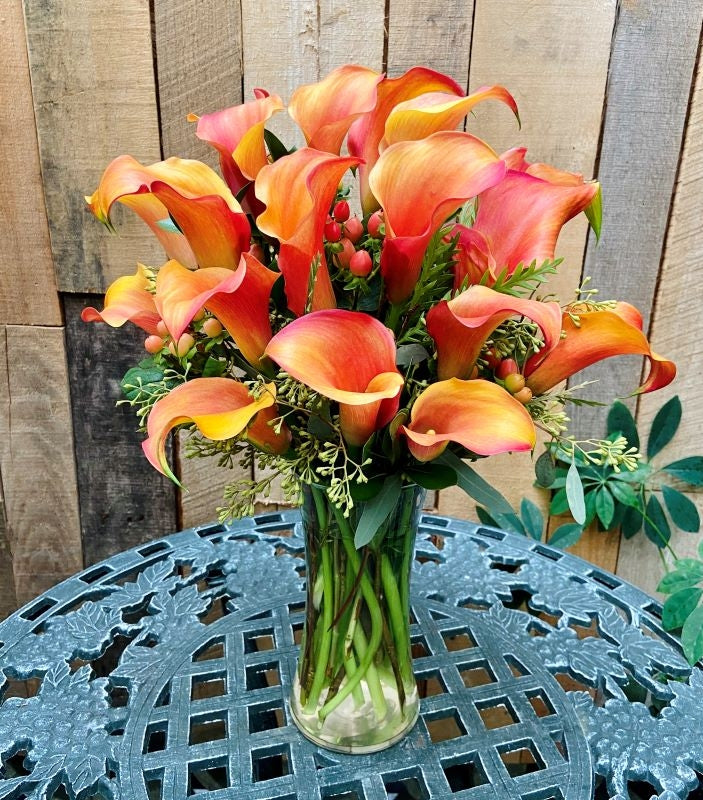 Autumn calla lilies with Fall accents in cylinder vase