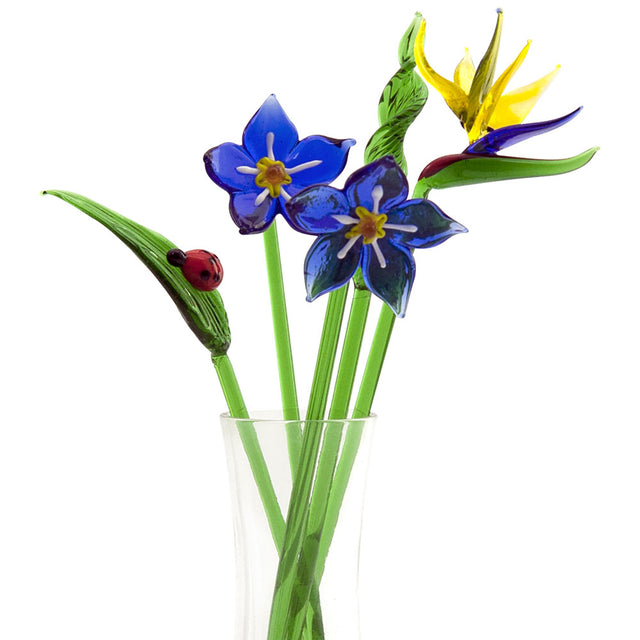 Bird of paradise glass flowers in vase with glass greenery