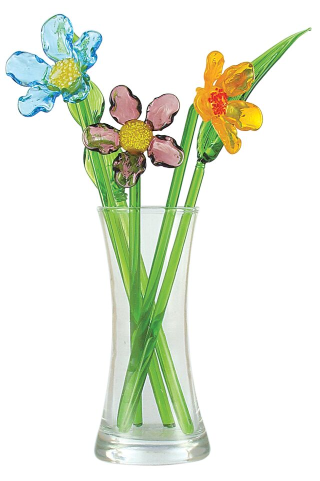 Vase of glass cosmos flowers with glass greenery in vase