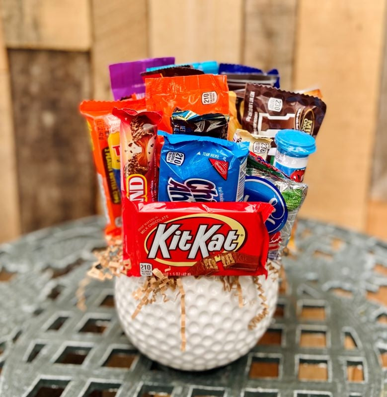 Ceramic golf ball with assorted snacks and candy