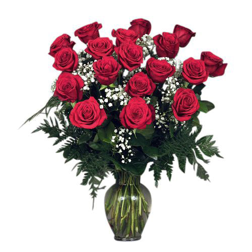 18 premium red roses arranged in a  vase with filler and greens