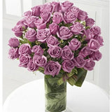 Luxury purple roses in cylinder vase