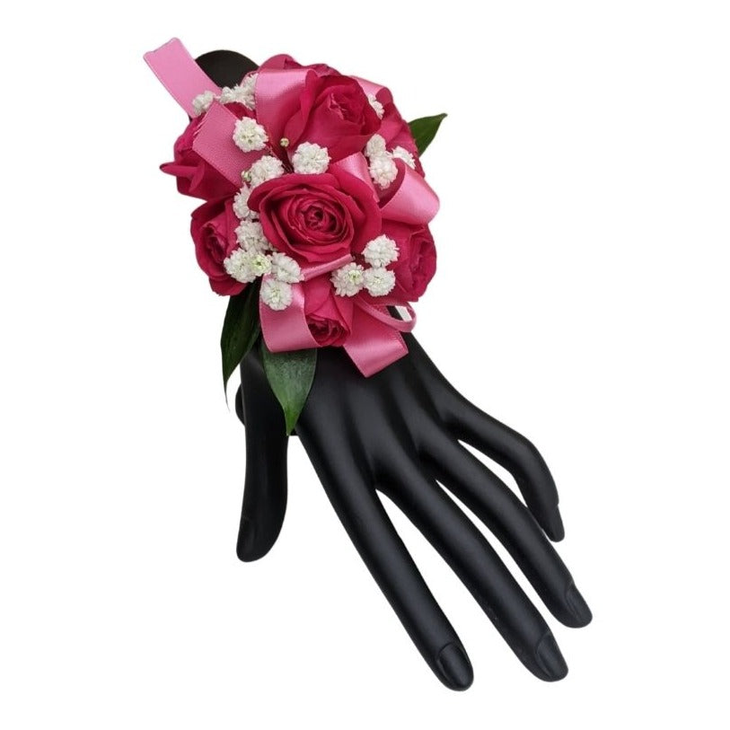 Hot pink rose corsage on wrist