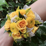 Wristlet corsage of assorted yellow flowers