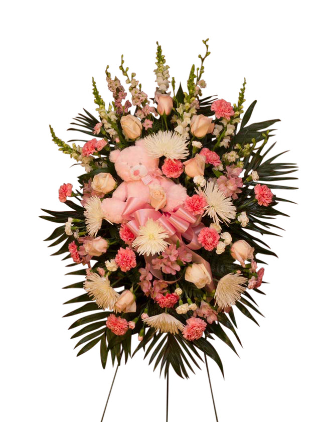 Themed funeral flower spray with teddy bear