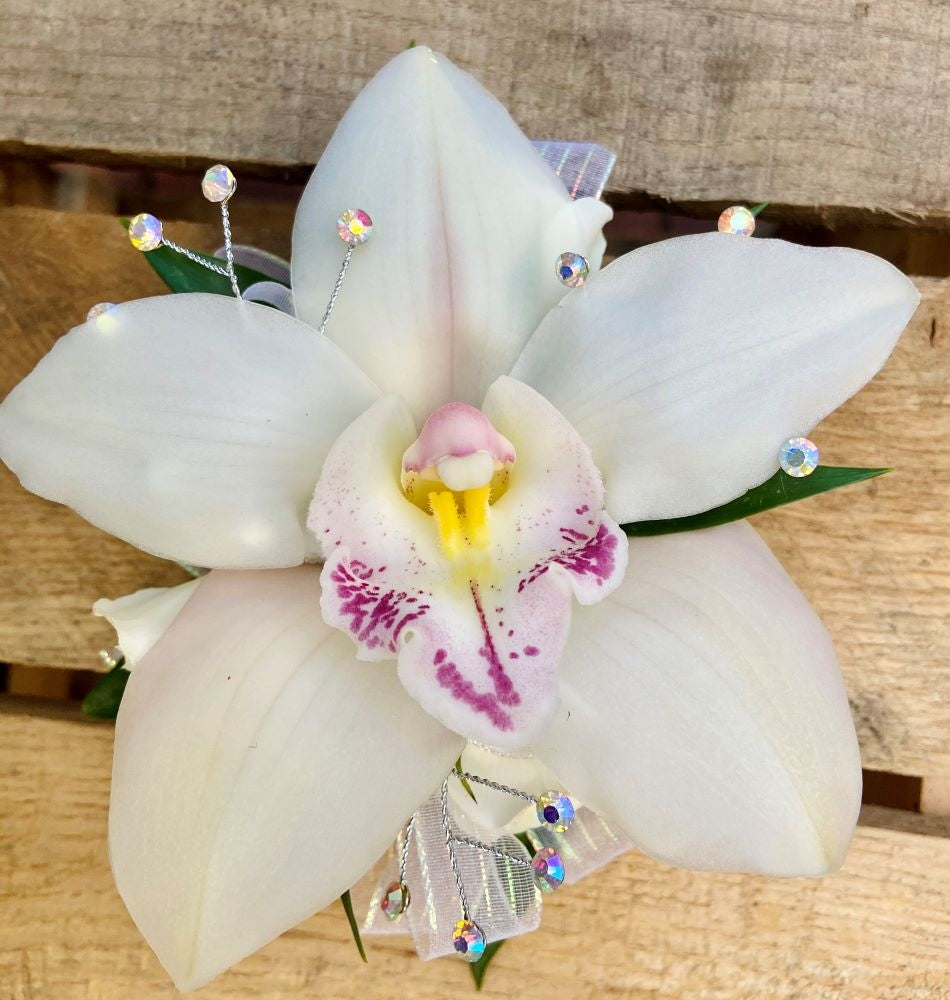 White orchid corsage with rhinestone accents